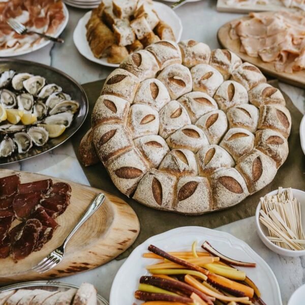 Grazing table with focaccia, oysters, cured meats and vegetables