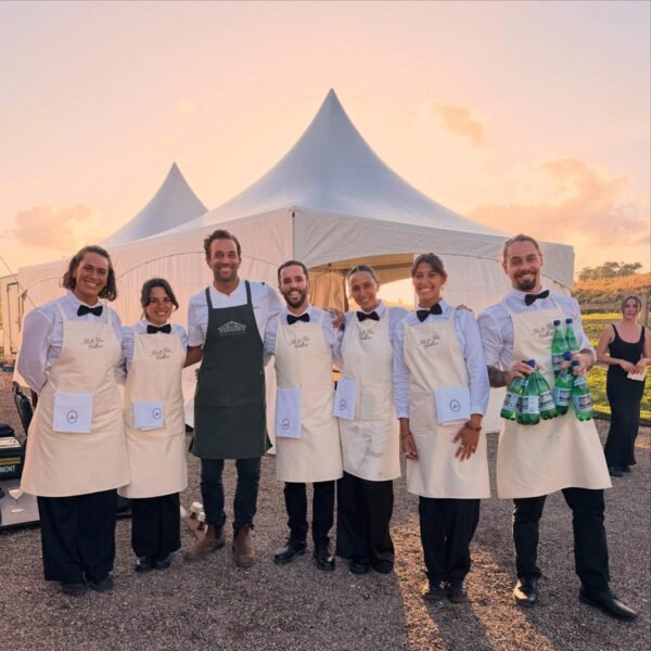 The Terra Catering team in front of an event marquee at sunset